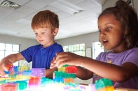 Preschool children playing at a light table at daycare